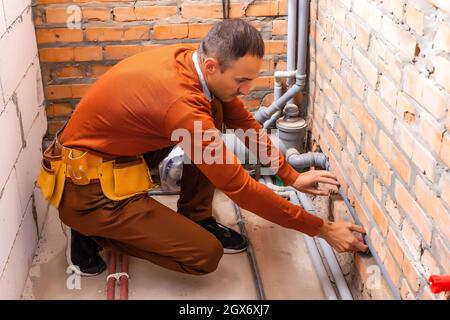 a plumber engineer repairing pipes at work Stock Photo