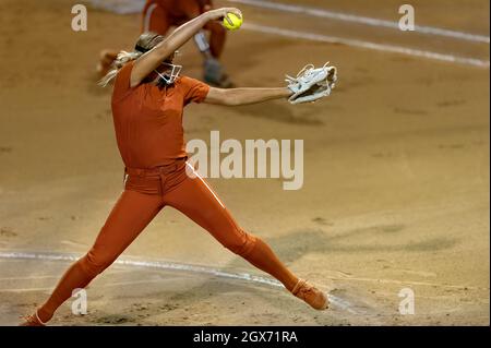 An Image Of A Softball Player Female Athlete Pitcher Is Winding Up To Deliver a Pitch To The Plate Stock Photo