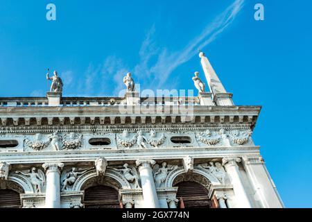 Detail of the exterior building of the Marciana National Library with marble statues and bas reliefs, in Saint Mark's square, Venice, Italy Stock Photo