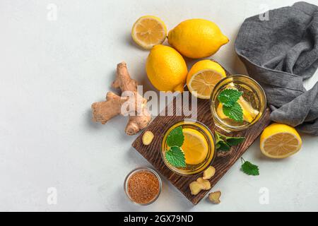 Ginger tea with lemon and mint on a gray background. A useful, immuno-strengthening tea. Stock Photo