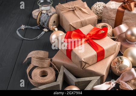 Gift boxes and golden Christmas decorations on a dark background. Side view, copy space. The concept of Christmas and New Year. Stock Photo