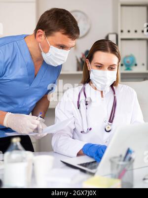 Two physicians working with laptop Stock Photo