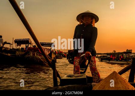 Our boat operator in Mekong on way to Cai Rang Floating Market. Stock Photo