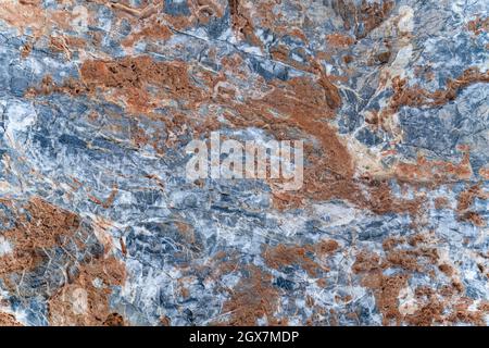Background texture of stone slab with gray-orange pattern. Layer of rust on surface of stone. Stock Photo