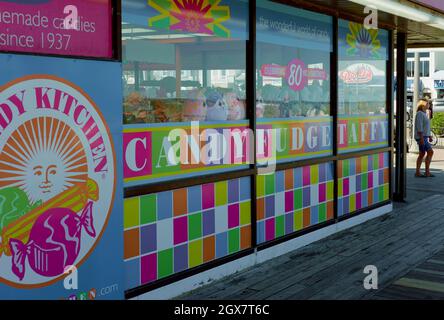 Colorful closeup of a Rehoboth Beach candy business window on the boardwalk.  Display features various candies and plush toys. Stock Photo