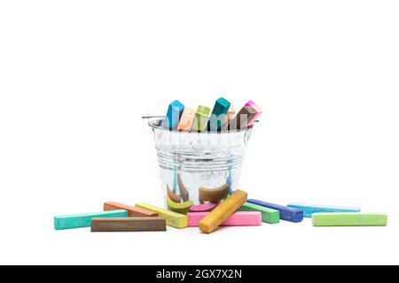 Square colorful pastel chalks is placed in a tin can and on a white background. Stock Photo