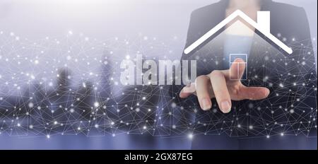 Smart home Automation Control System. Hand touch digital screen hologram Smart Home sign on city light blurred background. Real estate agent offer hou Stock Photo