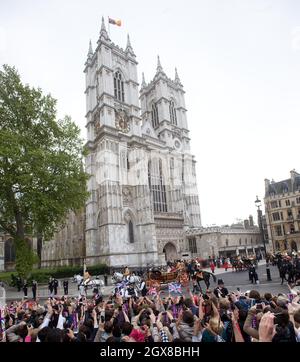 Prince William and his bride Catherine Middleton leave Westminster Abbey in an open carriage following their wedding ceremony on April 29, 2011. Stock Photo