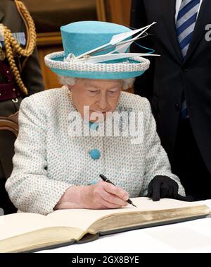 Queen Elizabeth ll signs the visitors book when she meets Irish Prime Minister Enda Kenny at the Government Buildings in Dublin on the second day of a historical State Visit to Ireland on May 18, 2011. **POOL PICTURES 28 DAY UK RESTRICTION *** Stock Photo