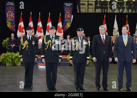 Prince Charles, Prince of Wales (C) and Canadian Prime Minister Stephen Harper (2nd right) attend a military ceremony at Fort York in Toronto on the second day of a Diamond Jubilee Tour of Canada on May 22, 2012. Stock Photo