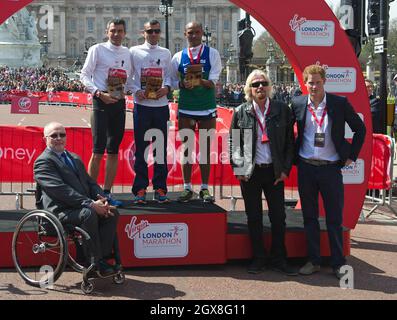 Prince Harry and Sir Richard Branson pose with competitors at the Virgin London Marathon 2013 on April 21, 2013 Stock Photo