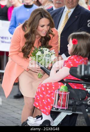 Catherine, Duchess of Cambridge receives flowers from hospice patient Sally Evans as she visits Naomi House Children's Hospice near Winchester. Stock Photo