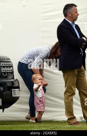 The Duchess of Cambridge holds Prince George of Cambridge as they visit ...