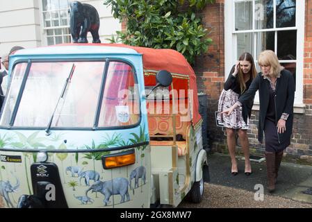Amber Le Bon and Joanna Lumley (right) inspect a rickshaw during the launch of 'Travels to my Elephant' Rickshaw Race at Clarence House in London on March 26, 2015. Stock Photo