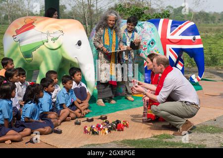 Prince William, Duke of Cambridge and Catherine, Duchess of Cambridge look at mini painted elephants at the Mark Shand Foundation in Kaziranga National Park , India on April 13, 2016. Stock Photo