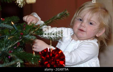 Jasmine Sumner, 3, helps with the decoration of the Christmas tree in the Orchard Room at Highgrove House, Tetbury, Gloucestershire. Ten excited youngsters were invited to the Prince's Highgrove estate in Gloucestershire to help the Royal couple decorate their Christmas tree. Charles and Camilla spent nearly an hour chatting and joking with the children, who were all being cared for at the Ty Hafan children's hospice in Barry, South Wales. Anwar Hussein/allactiondigital.com Stock Photo