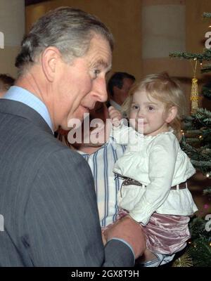 Jasmine Sumner aged 3 meets Charles, Prince of Wales during her visit to decorate the Christmas tree in the Orchard Room at Highgrove House, Tetbury, Gloucestershire. Ten excited youngsters were invited to the Prince's Highgrove estate in Gloucestershire to help the Royal couple decorate their Christmas tree. Charles and Camilla spent nearly an hour chatting and joking with the children, who were all being cared for at the Ty Hafan children's hospice in Barry, South Wales. Anwar Hussein/allactiondigital.com Stock Photo