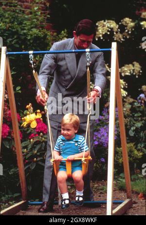 Prince William is given a push on a swing by Prince Charles as he celebrates his 2nd Birthday in the gardens of Kensington Palace on June 21st, 1984.  Charles jokingly nicknamed his son 'wombat' during the photocall. Royals, William, Charles,  Unusual, Casual, Child.  Â©Anwar Hussein/allaction.co.uk  Stock Photo