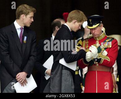 Prince William watches his brother, Prince Harry, help his father, the Prince of Wales, adjust his gloves on June 4th 2002 as they leave St Paul's Cathedral after a service of Thanksgiving to celebrate to the Golden Jubilee of the Queen.  Photo.  Anwar Hussein    Stock Photo