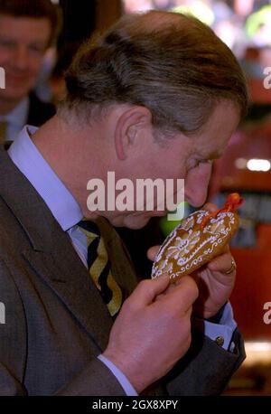 The Prince of Wales samples the aroma of a Biber Valentine Heart, the biscuit cooked to a Swiss recipe and is made out of ground hazelnuts, honey and kirsch. Anwar HUSSEIN/allaction.co.uk  Stock Photo