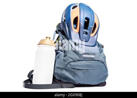 Protective helmet, backpack and water bottle, isolated on white background. Set of mountain biking accessories. Accessories for cycling. Stock Photo