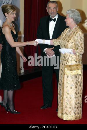 Madonna meets Her Majesty Queen Elizabeth II at the World Premiere of the James Bond film Die Another Day held at London's Royal Albert Hall. full length. curtsey. black dress. jewellery. hand shake. white gloves.   NO UK SALES FOR 3 MONTHS FROM 181102  Stock Photo