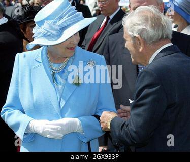 Britain's Queen Elizabeth II holds her handbag as she presides over the  Tynwald ceremony on the Isle of Man Stock Photo - Alamy