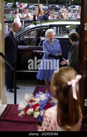 The Queen and the Duke of Edinburgh (left) are greeted by the Chairman of the Royal Albert Hall Charles Fairweather as Esme Goudie, 6, from Tufnell Park in north London, waits to present a posy of flowers as they arrive for this year's 17th BBC Prom held at the Royal Albert Hall in London.  Stock Photo
