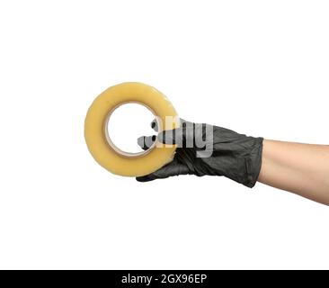 female hand in black latex glove holds roll of transparent  tape, white isolated background Stock Photo