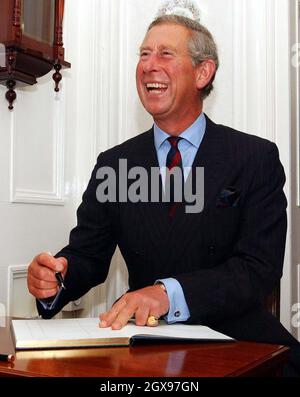 The Prince of Wales visits an organic farm on the penultimate engagement of his two day visit to Northern Irleand. Here he enjoys a joke as he signs the visitors book at Culmore House Organic Farm. Â©Anwar Hussein/allactiondigital.com  Stock Photo