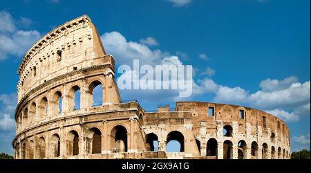 Rome, Italy. Arches archictecture of Colosseum (Colosseo) exterior with blue sky background and clouds. Stock Photo