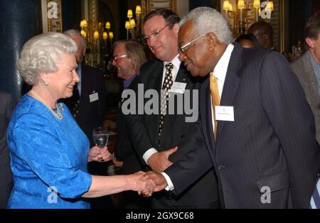 Queen Elizabeth II greets Sir Trevor McDonald at a reception at Buckingham Palace, London,  which aims to pay tribute to more than 400 pioneers of British Life. Â©Anwar Hussein/allactiondigital.com  Stock Photo