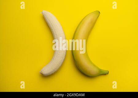 a peeled banana and a whole one in opposite position Stock Photo