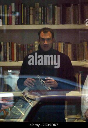 Johnny Vaughn and a friend walking in west London  and browsing in a book shop. A book called Johnny Got His Gun grabbed the TV presenters attention. Stock Photo