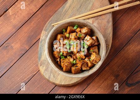 Sweet, spicy , crispy and fried Tofu in teriyaki sauce. Healthy vegan food, gluten-free Stock Photo