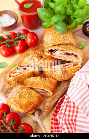 Italian stromboli, delicious pizza roll filled with sausage and ham Stock Photo