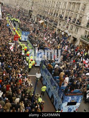 The England rugby team bus makes its way through the thousands of jubilant fans on Regent Street during the World Cup victory parade.