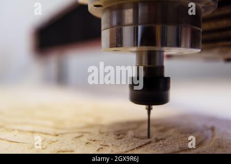 wood milling on modern automatic woodworking machine with CNC. furniture production. Stock Photo