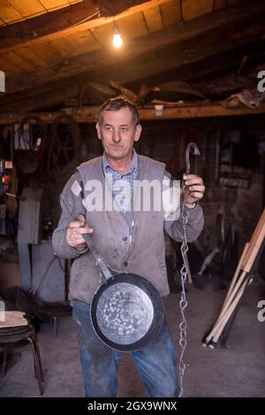 blacksmith traditional workshop A blacksmith worker showing forged iron ...