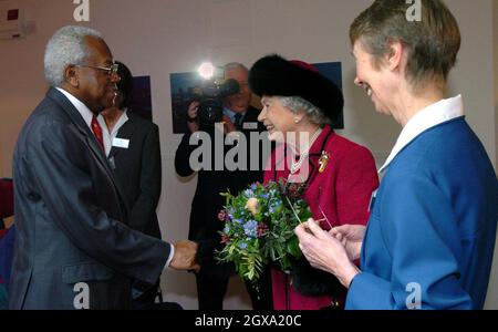 Britain's Queen Elizabeth II meets broadcaster Sir Trevor McDonald, a patron of Douglas House, a respite care home for young people with life-limiting genetic conditions, Oxford The Queen toured the home and looked at various facilities including the spa room, sensory room and music room before officially opening the house with a plaque unveiling. Â©Anwar Hussein/allactiondigital.com  Stock Photo