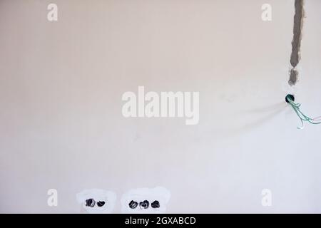 Socket back boxes with wires in a wall. Cabling background. electrical wires sticking out from electrical sockets hole on the wall. New electrical wir Stock Photo