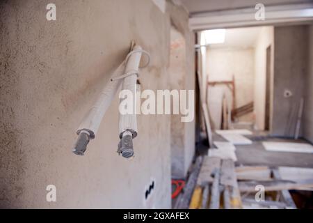 Socket back boxes with wires in a wall. Cabling background. electrical wires sticking out from electrical sockets hole on the wall. New electrical wir Stock Photo