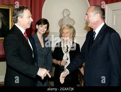 British Prime Minister Tony Blair (L) greets French President Jacques Chirac as their respective spouses look on prior to their meeting at 10 Downing Street in London, 18 December 2004. Chirac began a two-day visit to London Thursday for an annual Anglo-French summit with Iraq still a sore point in relations between the two European powers. Anwar Hussein/allactiondigital.com  Stock Photo