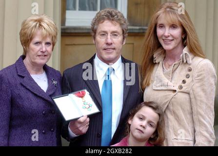 Roger Daltrey from the The Who poses with his wife Heather (right), sister Jill Dale (left) and grand-daughter Lily, 6,  in the courtyard of Buckingham Palace in central London, Wednesday February 9, 2005. The singer had just been honoured as a Commander of the British Empire (CBE) for services to music. Anwar Hussein/allactiondigital.com   Stock Photo