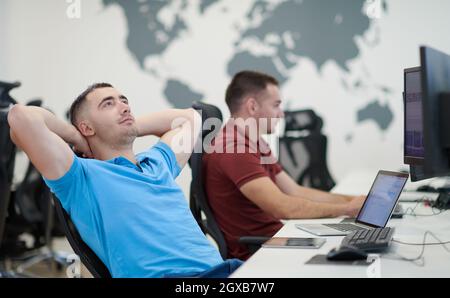 startup business, two male software developers working on computer at new modern open plan office Stock Photo