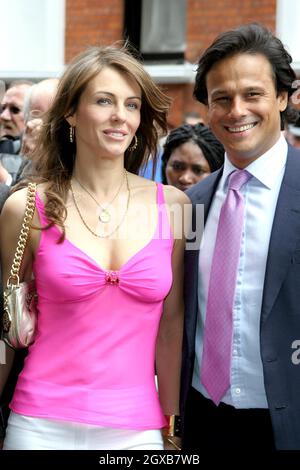 Elizabeth Hurley (Liz Hurley) and boyfriend Arun Nayar pictured outside Harrods in London. The model has developed her own beachwear collection called Elizabeth Hurley Beach which was launched at the exclusive department store. The collection conists of:  sarongs, tops, bags, sunhats and kaftans and much of collection features hand-beaded details embroidered in India, semi-precious stones and colourful prints inspired by artist Gustav Klimt. Stock Photo