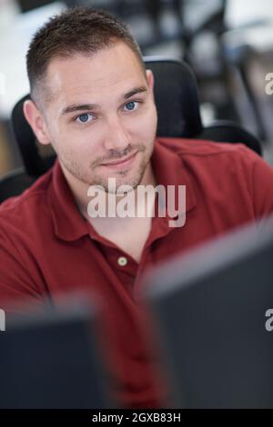 casual business man working on desktop computer in modern open plan startup office interior Stock Photo