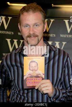 Morgan Spurlock pictured signing copies of his book Don't Eat This Book ...