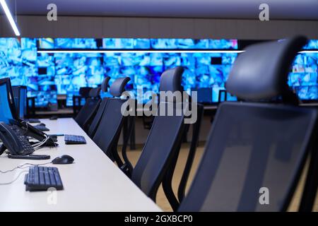 Empty interior of big modern security system control room, workstation with multiple displays, monitoring room with at security data center  Empty off Stock Photo