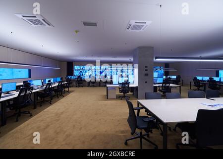 Empty interior of big modern security system control room, workstation with multiple displays, monitoring room with at security data center  Empty off Stock Photo